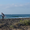 Surfer on the rocky beach at Majanichio inside, Fuerteventura.